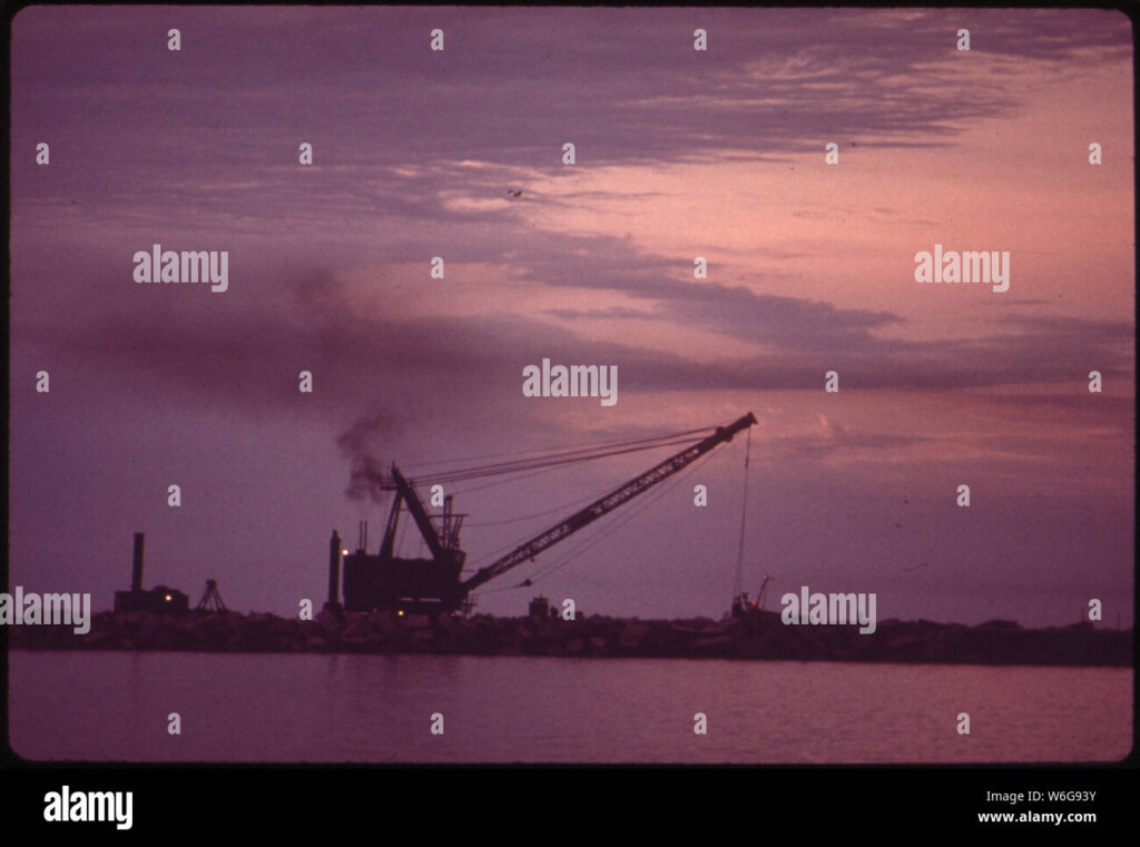 DREDGE BARGE AT WORK INSIDE BREAKWATER OF CONSUMER POWER PLANT AT 